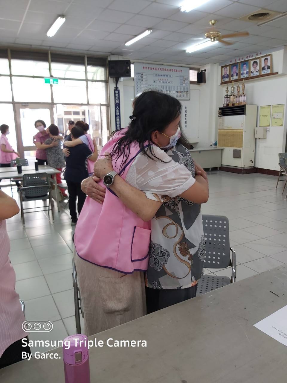 長者關懷據點課程中，兩位參與者以擁抱表達關懷
